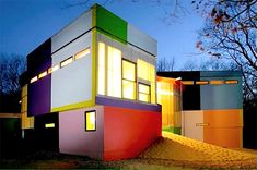 a multicolored house with its lights on at night