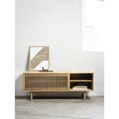 the sideboard is made out of wood and has an open shelf on one side