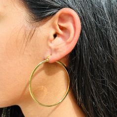 Our stunning  Large Gold Hoops, where boldness meets glamour. These hoop earrings make a striking statement and add a touch of luxury to any look. Hoop Size: 2mm x 55mm Experience the beauty and durability of 18 Karat Gold Filled. Our pieces are crafted with a thick layer of genuine 18 Karat gold bonded to a base metal, ensuring a long-lasting and high-quality piece of jewelry. Unlike gold-plated jewelry, gold filled hoops do not delaminate or peel, offering superior durability and a lasting gol Small Hoop Plug Earrings, Small Hoop Plug Earrings With Ear Wire, Everyday Single Hoop Plug Earring, Simple Hoop Earrings, Gold Bond, Gold Filled Hoops, Alessandra Ambrosio, Vanessa Hudgens, Jessica Alba