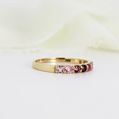 Ombre Ring Band in 14k Solid Gold, Half Eternity Gradient Pink Tourmaline Ring, Colorful Gemstone Ring, Anniversary Gift, October Birthstone . DETAILS ABOUT THE RING, MATERIALS AND STONE Ring Band: 14K YELLOW GOLD Ring Band size: 2.54mm wide band Gemstones: 2mm natural pink gradient tourmalines. Pave setting. 2mm tall from finger. Total 7 pink tourmalines. Matching hoop earrings are available from this link; https://www.etsy.com/listing/1164157904/pink-tourmaline-hoop-earrings-14k-gold? SIZE : P Yellow Gold Multi-stone Sapphire Promise Ring, 14k Gold Multi-stone Eternity Band, Pink Gold Sapphire Ring With Gemstone, Pink Sapphire Ruby Ring With Multi-stone For Gift, Multi-stone Sapphire Promise Ring, Fine Jewelry Multi-stone Sapphire Promise Ring, Promise Yellow Gold Multi-stone Sapphire Ring, 14k Gold Multi-stone Stackable Rings, Promise Multi-stone Sapphire Ring In Yellow Gold