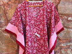 This Beautiful Hand Block Print Short Caftan or can be called as Tunic is made with super fine quality cotton and designs have been crafted by Handprints. Fabric - 100% Cotton Color - Red Pattern - Flower Block Print Size - Plus Size, can fit Up to 4XL Bust size - Free Size (Drawstring) Short Caftan- 35" Inches (Approx.) * It has Adjustable Drawstring Waist. * V Shape Neck Which is 8" Inches Deep. * Very comfortable to wear in both hot and cold weather. Note: The color and brightness of actual p Summer Cotton Tunic Sets, Bohemian Cotton Sets With Short Sleeves, Printed Cotton Beach Sets, Printed Cotton Sets For Beach, Traditional Cotton Dress With Kimono Sleeves, Multicolor Cotton Tunic Kimono, Free Size Cotton Short Sleeve Kaftan, Summer Cotton Sets With Kimono Sleeves, Cotton Sets With Kimono Sleeves For Summer