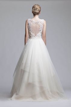 the back of a wedding dress with an illusional neckline and tulle skirt