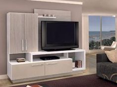 a living room with a couch, television and entertainment center