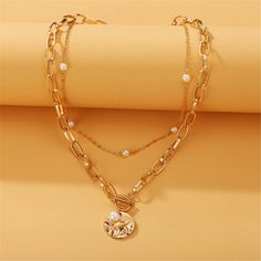 Top off your everyday ensembles with this gleaming 18k gold-plated necklace flaunting a Figaro-style chain and pearl pieces for iridescent accessorizing. Chain 1 : 15.55" L with 2.95" extender Chain 2 : 20.87" L Lobster claw clasp 18k gold-plated copper / pearl Double Necklace, Coin Pendant Necklace, Pearl Pendant Necklace, Delicate Jewelry, Vintage Pearls, Color Dorado, Coin Necklace, Coin Pendant, Beaded Choker