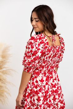 You’ve just secured your new favorite dress! The Elaine Dress is the epitome of beauty, featuring a bold, red floral pattern that makes a statement in any setting. The flattering square neckline and puff sleeves elevate your look, while the form-fitting bodice and tiered midi skirt create an elegant silhouette you’ll love. STYLE INFO & CARE The smocked bodice for a flexible, comfortable fit Tiered Skirt Skirt lined 100% polyester Tie detail in the back Maternity friendly style Machine Washable i Red Floral Print Puff Sleeve Dress, Floral Square Neck Dress With Smocked Bodice, Red Smocked Bodice Dress With Square Neck, Red Fitted Puff Sleeve Dress For Spring, Red Square Neck Dress For Brunch, Square Neck Floral Dress, Elaine Dress, Red Floral Pattern, Tiered Midi Skirt