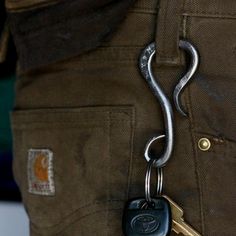 a close up of a person's pants with a key in the back pocket