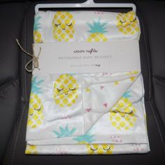 the baby blanket has pineapples on it