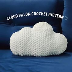 a cloud pillow sitting on top of a blue bed with the words cloud pillow crochet pattern