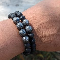 This is a beautiful handcrafted Damascus Beads Bracelet with Lava Stone in a "Perfect Round Shape" pattern. Damascus steel is a unique type of steel that features a high carbon content and alternating pale and shadowy grains that create distinctive patterns. Comes with instructions to care for the product. Lava Stone is a unique type of stone with a tiny hole on it which shows its own shape with gothic theme. In Medium Size if you order beads with 2 Damascus Ball you will get 17 beads. (Length 1 Hand-strung Lava Stone Bracelets, Silver Beaded Bracelets With 8mm Lava Stone Beads, Silver Lava Stone Beaded Bracelets With 8mm Beads, Hand-strung Lava Stone Bracelets With Round Beads, Handmade Adjustable Lava Stone Beaded Bracelets, Handmade Spiritual Lava Stone Beaded Bracelets, Gothic Theme, Gothic Themes, Types Of Steel