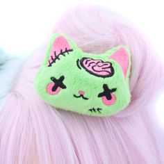 "Add a touch of adorable undead charm to your look with our Plush Anime Style Kawaii Zombie Kitty Hair Clip! Crafted from bright lime green minky fabric, this hair clip features a sweet-faced kitty with hot pink brains and stitches embroidered using the highest quality threads. Each detail is meticulously designed and digitized by me, ensuring a unique and delightful accessory. Handmade with love in the USA, this super cute zombie kitty hair clip is perfect for adding a playful twist to your ens Yume Kawaii Hair Accessories, Kawaii Plush Hair Clip, Pink And Green Accessories, Cute Face Accessories, Zombie Cosplay Female, Cute Costume Accessories For Halloween Cosplay, Cute Halloween Costume Accessories, Pastel Goth Accessories, Zombie Accessories