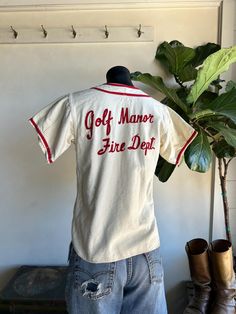 Awesome Vintage 1950s Cotton Wool Embroidered Baseball Uniform Jersey Shirt by Okrents Sporting Goods. Red and white in color, made from cotton/wool fibers in Cincinnati, Ohio. Fire Dept issued league jersey. Chainstitched embroidery on back. Jersey has a front three button closure. Condition overall is good with only minor flaws that include; there are a few light spots on back of jersey. No harsh staining, rips, or tears. Please see all photos for details. Refer to measurements below to ensure a proper fit (modeled on a size small mannequin) fits true to size 18" pit to pit 16" shoulder to shoulder 25" in length Small Mannequin, Uniform Shirt, Light Spots, Uniform Shirts, Embroidered Baseball, Cincinnati Ohio, Fire Dept, Cotton Wool, Des Moines