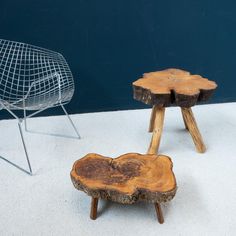 two wooden stools sitting next to each other on top of a white carpeted floor