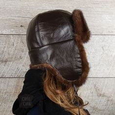 Real brown mink fur aviator hat, brown leather, Charles model, for women. Unisex. This hat will go perfectly with those wanting to combine beauty and practicality. Mink fur adds a touch of classic and sophistication to this accessory. This chapka can be worn in three ways using the drawstrings:1. Attached under the chin for colder days.2. Tied up, for warmer days.3. Tied towards the back, your ears and neck are covered while having the earflaps raised. Very practical! So, ideal depending on the temperature or the desired style. Warmer than the competition, this model has earflaps long enough to protect the cheeks and neck against the cold and wind. In addition, the interior is lined with a very soft, non-irritating black woolen fabric, which will keep you warmer than a usual quilted lining Brown Sheepskin Hat With Faux Fur Lining, Brown Hat With Faux Fur Lining And Ear Flaps, Brown Hats With Faux Fur Lining And Ear Flaps, Brown Leather Hats With Faux Fur Lining, Winter Brown Aviator Hats, Brown Aviator Winter Hats, Brown Winter Hats, Brown Faux Fur Hat With Ear Flaps, Fur Hat Men