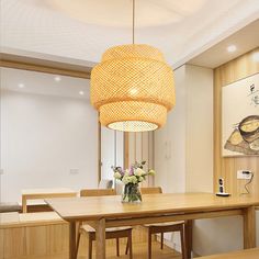 a dining room table with chairs and a chandelier hanging from it's ceiling