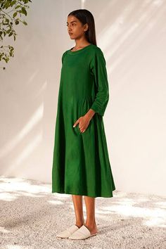 Forest green midi dress with gathers on the sides and smocking detail on the sleeves.
Components: 1
Pattern: Embroidered
Type Of Work: Running Stitches
Neckline: Round
Sleeve Type: Long
Fabric: Linen
Color: Green
Other Details: 
Embroidered neckline
Side seam pockets
Closure: Back zipper
Occasion: Resort,Party - Aza Fashions Solid Color Knee-length Dress With Pleated Sleeves, Solid Knee-length Dress With Pleated Sleeves, Solid Color Knee-length Midi Dress With Pleated Sleeves, Spring Dark Green Midi Dress, Casual Midi Dress With Pleated Sleeves For Daywear, Green Midi Dress With Pleated Sleeves For Summer, Solid Color Midi Dress With Gathered Sleeves, Solid Knee-length Midi Dress With Gathered Sleeves, Solid Midi Dress With Gathered Sleeves, Knee-length