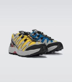 A reissue of the iconic XA-Pro racing silhouette, these sneakers from Salomon come in a sulphur and indigo bunting colorway with yellow accents, and are updated with reinforced toe caps and heel guards, versatile lug patterns at the soles, and Quicklace™ eyelets..Upper: fabric.Toe shape: round toe.Trim: leather.Sole: fabric insole, rubber sole.Fits slightly small to size - we recommend trying a half size larger.UK sizes Salomon Sneakers, Indigo Bunting, Fashion Mood Board, Yellow Accents, Leather Accents, Personal Shopping, Lightweight Fabric, Cityscape, Rubber Sole