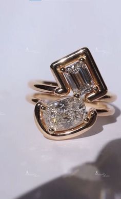 two diamond rings sitting on top of each other