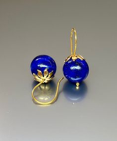 Beautiful vibrant and high-grade lapis lazuli globe earrings. The 12.5 mm lapis lazuli globes have a gorgeous deep vibrant royal blue color that shows celestial flecks of golden pyrite in the stone. The ultra-fine globes attached to a beautiful 24K gold Vermeil/ Sterling Silver ear wires. These are elegant and perfect earrings to go with any outfit. A pair of fine gemstone essentials. *AAA high-grade lapis lazuli globes *Ball size (diameter): 12.5 mm *Metal:24K Gold Vermeil/ Sterling Silver *Ear Round Lapis Lazuli Gemstone Earrings, Handmade Round Lapis Lazuli Earrings, Pierced Lapis Lazuli Round Jewelry, Blue Lapis Lazuli Earrings, Blue Lapis Lazuli Earrings For Formal Occasions, Blue Round Beads Spiritual Earrings, Royal Blue Lapis Lazuli Round Jewelry, Blue Spiritual Earrings With Round Beads, Formal Blue Lapis Lazuli Earrings