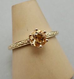 "Return Policy: Unless the item is not as described on the listing there's a $35.00 cost for the postage and handling that will be deducted from the refund.Most of our jewelry is ready to send out within one or two days. Email and ask us about this listing. This is a very petite vintage style ring is made in 14k gold the center is a natural 5.5 mm round Imperial Topaz                                                                the weight is approximately .70 carats.   There is a matching band Vintage Topaz Engagement Rings, Engagement Ring Citrine, Yellow Topaz Engagement Ring, Imperial Topaz Engagement Ring, Topaz Engagement Ring Yellow, Imperial Topaz Jewelry, Orange Engagement Ring, Imperial Topaz Ring, Yellow Topaz Ring