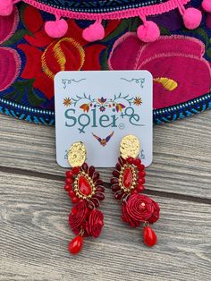 These beautiful Artisanal earrings are hand made with beads and the flowers are palm leaf. They are the perfect accessory and pop of color for your outfit! These earrings are made in Mexico by Mexican Artisans with love for you to look gorgeous. More options available here: https://www.etsy.com/es/listing/1042983385/aretes-mexicanos-florales-de-palma?ref=listing_published_alert Mexican Accessories, Traditional Mexican Dress, Colorful Headbands, Mexican Hat, Embroidered Belt, Mexican Jewelry, Traditional Earrings, Mexican Dresses, Floral Embroidered Dress