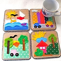 four coasters that have been made to look like cars and houses on them, one has a coffee cup in the middle