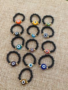 several bracelets with evil eyes on them