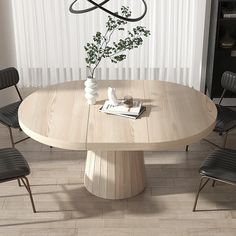 a round wooden table with four chairs around it and a vase on the table next to it