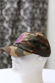 With unique designs you won't find anywhere else, our caps are the quality type that are designed with a thicker woven fabric. Not those flimsy weak ones that lose shape. 100% stitched embroidered design. Sport cap. Curved brim. Dry Clean Only Comes in: adjust back. Perfect for those debonair que dawgs who needs head/face protection from the sun, sweat and elements while out doing fitness, events or anything fun. Camouflage Curved Bill Baseball Cap, Outdoor Camouflage Cotton Baseball Cap, Adjustable Camouflage Cotton Baseball Cap, Adjustable Cotton Camouflage Baseball Cap, Brown Dad Hat With Curved Visor And Adjustable Fit, Streetwear Camouflage Baseball Cap With Curved Bill, Camouflage Cotton Snapback Hat, Camouflage Baseball Cap With Curved Bill For Streetwear, Curved Bill Camouflage Hats For Streetwear