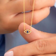 14k Gold and diamond evil eye necklace with sapphire, ruby and emerald center stone options. Diamond: 0.10 ct diamond Charm Measurements: 10 mm x 5 mm ( 0.4 inch. x 0.5 inch ) Chain: 1.1 mm link chain Chain length: 14+2 or 16+2 inch options ( Please let us know if you want a different length) Color: G Quality: SI-VS Additional Notes: * Non-Conflict Diamonds * Made in the USA C U R R E N T ∙ T U R N A R O U N D Processing Time: 1-2 weeks Within United States: approx. 3-5 biz days (faster shipping Diamond Evil Eye Jewelry In Yellow Gold, Yellow Gold Diamond Evil Eye Jewelry, Yellow Gold Diamond Jewelry With Evil Eye, Evil Eye Diamond Jewelry As Gift, Diamond Evil Eye Jewelry Gift, Evil Eye Diamond Jewelry Gift, Spiritual Diamond Birthstone Jewelry, Gold Diamond Jewelry With Evil Eye Detail, Gold Diamond Jewelry With Evil Eye