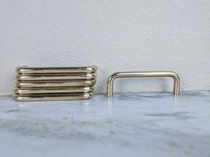 a stack of brass handles sitting on top of a marble counter