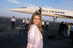 a woman standing in front of an air france plane