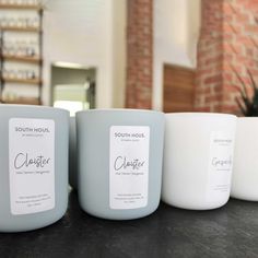 three white candles sitting on top of a counter