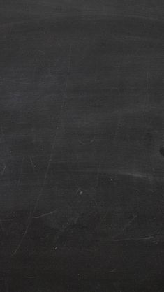 a man holding a tennis racquet in front of a blackboard with writing on it