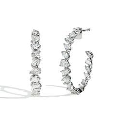 Gorgeous pair of mixed fancy shape diamond inside out hoop earrings featuring emerald cut diamonds, pear shapes, and marquise diamonds in 18k white gold. Pair it with our other Private Label pieces from our Fancy Shape Diamond collection for the perfect look. Fancy Shape Diamond Earrings, Marquise Baguette Diamond Jewelry In White Gold, Modern Platinum Jewelry With Marquise Cut, Modern Platinum Jewelry Marquise Cut, Modern Marquise-cut Platinum Jewelry, Modern Marquise Cut Platinum Jewelry, Silver Marquise Jewelry With Baguette Diamonds, Platinum Jewelry With Baguette Diamonds In Marquise Cut, Platinum Jewelry With Baguette Diamonds And Marquise Cut