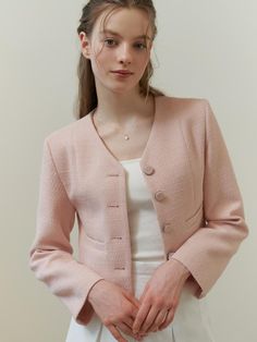 This piece of clothing is a textured jacket featuring a notched lapel and a three-button closure. This piece of clothing is a textured jacket featuring a notched lapel and a three-button closure. It is tailored with a structured fit and includes two patch pockets on the front. The sleeves are full-length, and the overall design exudes a formal yet contemporary aesthetic.- The jacket presents a sophisticated appearance with its notched lapels and button details.- Patch pockets add both function and a casual touch to the otherwise formal item.- Its textured fabric contributes to a rich, tactile experience and visual depth. Formal Tweed Button-up Blazer, Formal Tweed Blazer With Double Button Closure, Elegant Double-breasted Cropped Jacket With Double Button, Tweed Blazer With Hidden Button Closure And Notch Lapel, Tweed Blazer With Hidden Button Closure And Lapel Collar, Tweed Blazer With Double Button For Business Casual, Elegant Tweed Blazer With Hidden Button Closure, Elegant Single Button Tweed Jacket For Winter, Elegant Single-button Tweed Jacket For Winter