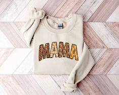 Mama Fall Sweatshirt, Fall Crewneck, Mama Sweater, Fall Sweater, Mama Crewneck, Fall Mama Shirt, Fall Mama Sweater This crewneck sweatshirt is pure comfort. Made from a soft cotton/poly blend with no itchy side seams, this is sure to become a staple. SIZE AND FIT: Your sweatshirt design will be printed on a high-quality, soft and comfortable unisex sweatshirt. Sizes run true to size, which takes the guesswork out of ordering; if you like your sweatshirts loose or oversized, you might want to ord Fall Mama Sweatshirts, Mama Sweater, Mama Sweatshirt, Fall Sweatshirt, Fall Sweaters, Sweatshirt Designs, Mama Shirt, Women's Style, Unisex Sweatshirt