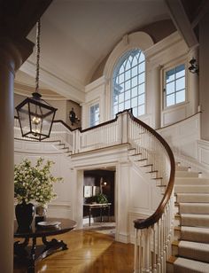 a staircase in a house with white walls and wood floors