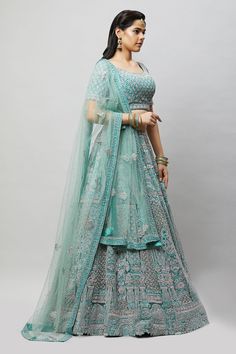 A beautiful sea green lehenga with tonal and silver stonework! Fabric: Net with satin lining All preorders will be handled by a Nazranaa Bridal Consultant who will virtually discuss measurements and minor changes according to the client's specifications Occasion: Wedding Reception WASH CARE INSTRUCTIONS - Please Dry clean only when it is applicable. Slight color variation is possible due to digital photography. Jewelry not included Turquoise Embroidered Lehenga For Wedding, Designer Turquoise Embroidered Lehenga, Designer Embroidered Turquoise Lehenga, Turquoise Embroidered Wedding Lehenga, Turquoise Bollywood Sets For Reception, Bollywood Style Turquoise Sets For Reception, Bollywood Turquoise Sets For Reception, Turquoise Lehenga With Dupatta For Reception, Turquoise Choli With Dupatta For Wedding