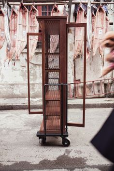 a wooden cabinet sitting on top of a sidewalk