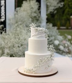 a white wedding cake sitting on top of a table