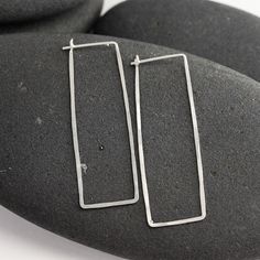 "These silver and 14K white gold rectangle hoops have been hand formed and hammered for strength and a subtle texture that sparkles. The posts tuck into a loop catch on the backside of the earring, so there's no risk of losing backs. Modern, elegant, feminine and bold, these earrings are always in style and will always match. This particular pair of earrings from the line is a long rectangle - 1 7/8 inches long and about 5/8\" wide. Made from responsible and recycled metals - sterling silver and Hammered Sterling Silver Jewelry In Rectangular Shape, Hammered Rectangular Sterling Silver Jewelry, Rectangular Hammered Sterling Silver Jewelry, Minimalist Hammered Rectangular Earrings, Everyday Hammered Rectangular Jewelry, Modern Hypoallergenic Rectangular Jewelry, Modern Hammered Rectangular Earrings, Modern Nickel-free Rectangular Hoop Earrings, Minimalist Rectangular Hoop Earrings, Hypoallergenic