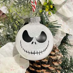 a white ornament with a jack skellingy face on it's side