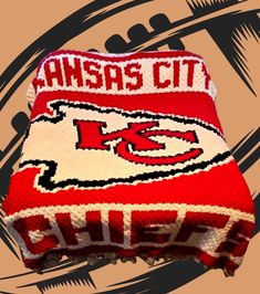 a red and white knitted beanie with the word kansas city chiefs on it