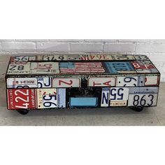 an old suitcase covered in license plates