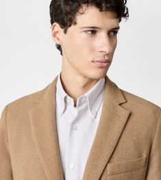 Unlined blazer in wool and cashmere jersey, characterized by lapels, breast pocket with leather piping and patch lower pockets, one with an embroidered T. Fastened with branded buttons, it interprets an informal and relaxed elegance. Winter Business Casual Tweed Jacket With Pressed Crease, Luxury Tweed Jacket With Welt Pockets And Lapel Collar, Brown Wool Blazer With Pressed Crease, Luxury Sport Coat With Suit Collar For Fall, Modern Winter Blazer With Welt Pockets, Winter Business Tweed Jacket With Pressed Crease, Winter Semi-formal Blazer With Welt Pockets, Semi-formal Winter Blazer With Welt Pockets, Semi-formal Blazer With Concealed Placket For Fall