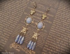 "Luminous opaque blue Egyptian Revival earrings made with stunning vintage Egyptian style Czech glass scarab cabochons, vintage Egyptian style connectors, and blue Czech glass beads. They make the perfect handmade gift for women who love vintage style Art Deco jewelry. They are extra long at just over 4.5\" and come with lead/nickel free antique brass ear wires. Different wire styles available upon request - just ask. Ready to ship within 1-3 business days. '**......**' Designed, created and pho Vintage Blue Brass Earrings, Vintage Blue Drop Earrings Jewelry, Vintage Blue Drop Earrings, Egyptian Revival Jewelry, Egyptian Style, Vintage Style Art, Earrings Art, Egyptian Revival, Earrings Inspiration