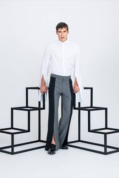 This color blocked design is all about elongation; the contrasting black and grey panels are seamed on the center of the leg, emphasising a long silhouette. They have a straight leg with a slit at the bottom, from the hem towards the knee, creating a wide leg effect. They will be a fresh edgy addition to your wardrobe, wear them with a dress shirt and an oversized blazer, or let their silhouette be the star and pair them with a classic tee! Two Tone Pants, Drop Shoulder Shirt, Hem Pants, Best Dressed Man, Grey Panels, Mens Luxury Fashion, Mens Designer Fashion, Oversized Blazer, Modern Man