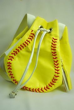 a yellow purse with a baseball stitch on it