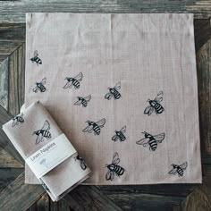 two napkins with bees on them sitting next to each other