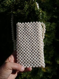 Introducing our exquisite handmade faux pearl beaded phone bag - the perfect combination of elegance and functionality, meticulously crafted to elevate your everyday accessories. Each phone case is lovingly handcrafted from high-quality materials, including shiny faux pearl beads that add a touch of sophistication to your ensemble. Measuring approximately 7 inches tall and 4 inches wide, this bag is designed to comfortably fit most smartphones, making it an ideal accessory for both casual outing Elegant Square Phone Bag As Gift, Party Beaded Rectangular Phone Bag, Beaded Rectangular Phone Bag For Parties, Party Rectangular Beaded Phone Bag, Rectangular Beaded Phone Bag For Parties, Elegant Evening Phone Bag, Elegant White Square Phone Bag, White Rectangular Phone Bag For Party, Elegant Rectangular Evening Phone Bag